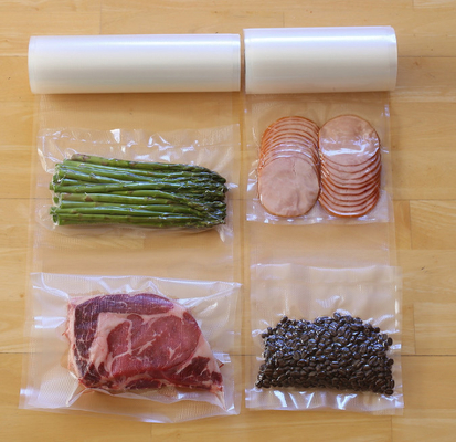 食品等級のナイロン透明な真空シール袋のロールスロイスの織り目加工のプラスチック生鮮食品